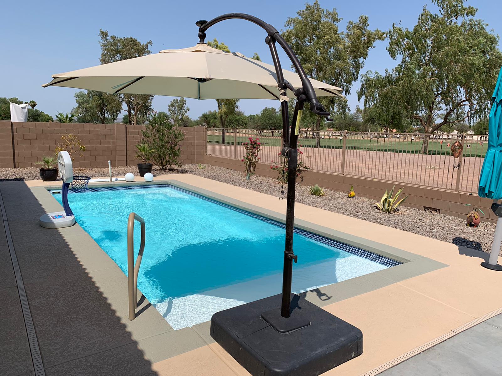 Compact backyard pool and patio
